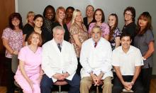 Dr. Neil Woods (front row, 2nd from left) found Sterling Practice Management in time to revitalize his practice
